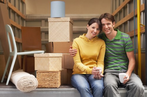 Professional movers carrying boxes in a Streatham flat move